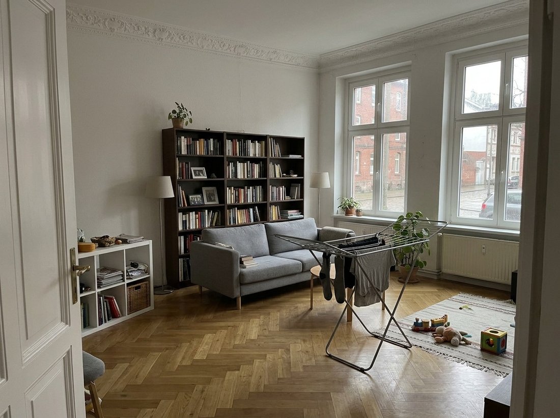 Lived-in bedroom containing personal belongings, laundry, and untidy bedding.