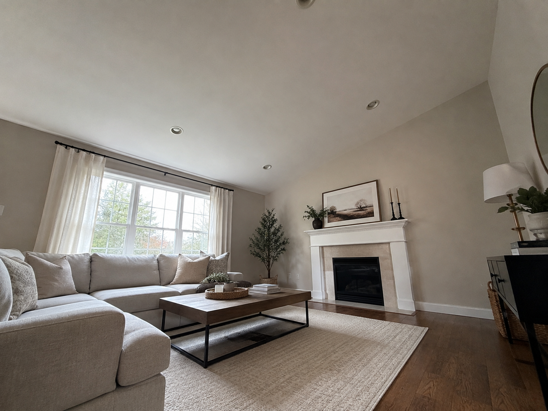 Living room photographed with a tilted phone and stretched furniture.